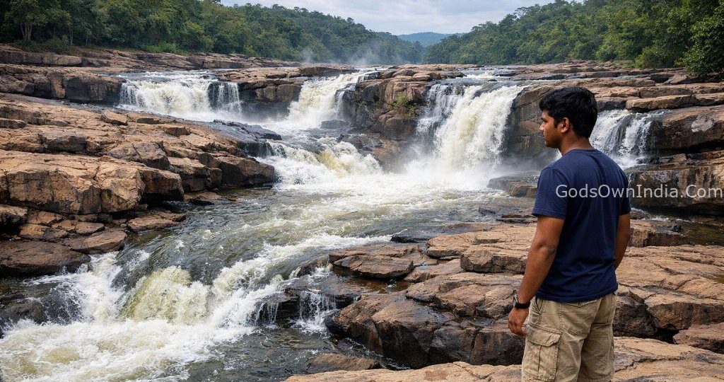 Perunthenaruvi Waterfalls Kerala with a young visitor observing safety.