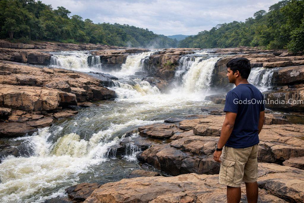 Perunthenaruvi Waterfalls Kerala with a young visitor observing safety.
