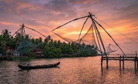 Kumbalangi Nights movie location: Chinese fishing nets at sunset in Kochi, Kerala.