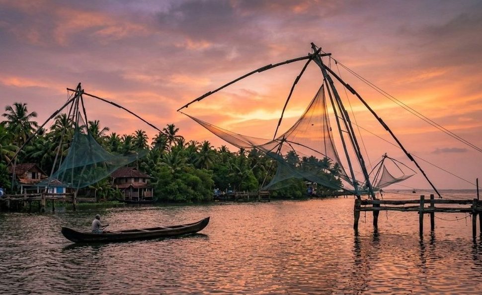 Kumbalangi Nights movie location: Chinese fishing nets at sunset in Kochi, Kerala.