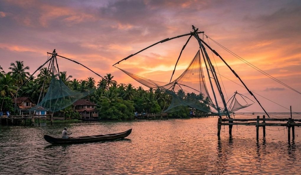 Kumbalangi Nights movie location: Chinese fishing nets at sunset in Kochi, Kerala.