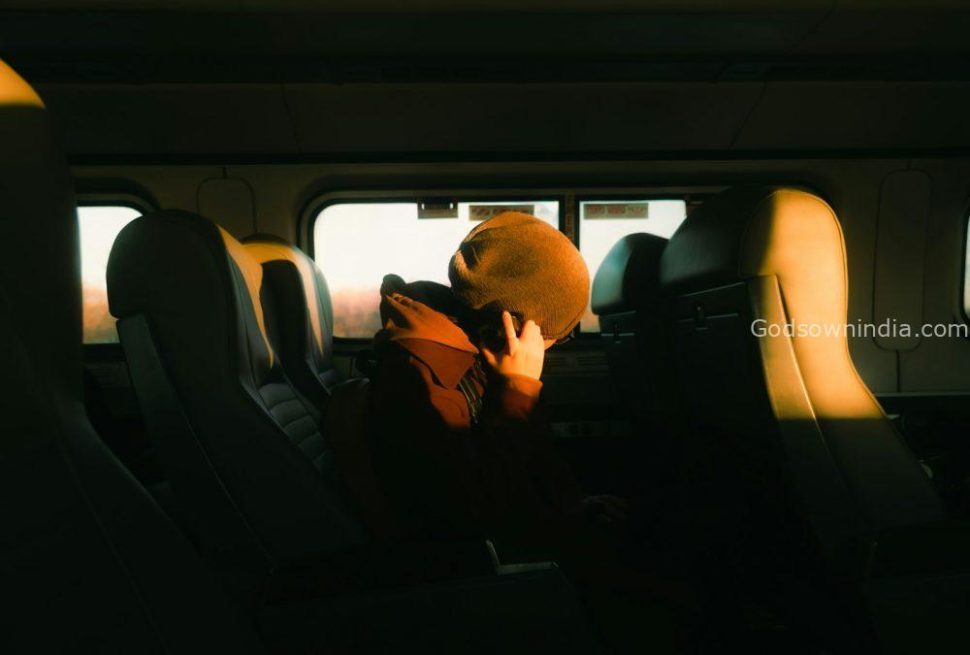 Person sleeping on a train during sunset.