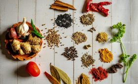 a variety of spices on a white table