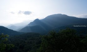 the sun shines on the mountains in the distance