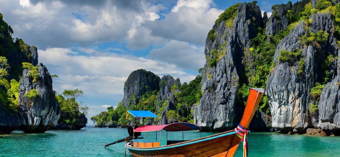 A vibrant, sun-drenched landscape showcasing a traditional Thai longtail boat