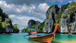 A vibrant, sun-drenched landscape showcasing a traditional Thai longtail boat