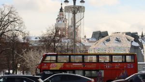 a red double decker bus driving down a street