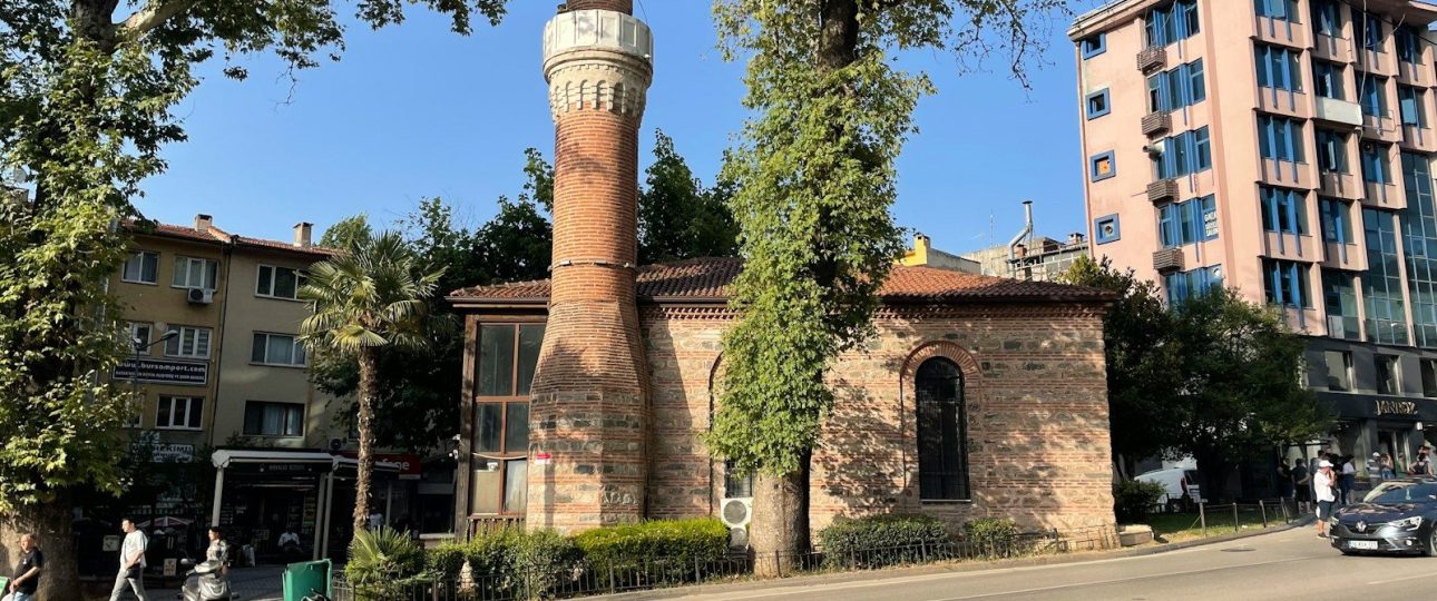 a tall brick building sitting on the side of a road