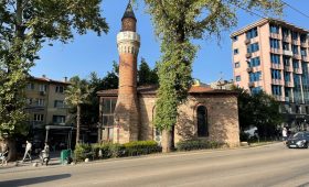 a tall brick building sitting on the side of a road
